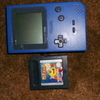 blue game boy pocket with a red back and pac man advance