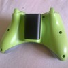 lime green xbox 360 controller with black battery case on back