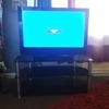flat screen tv and black glass stand