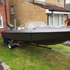 Speedboat with 80hp mariner outboard ready to launch on trailer